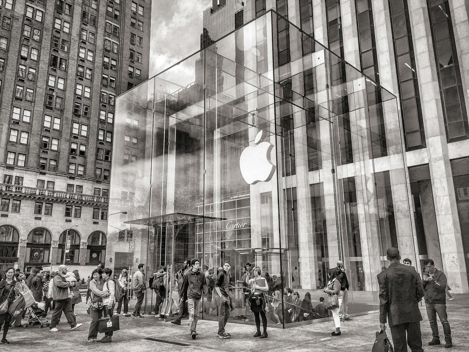 Group of People Walking in Apple Center